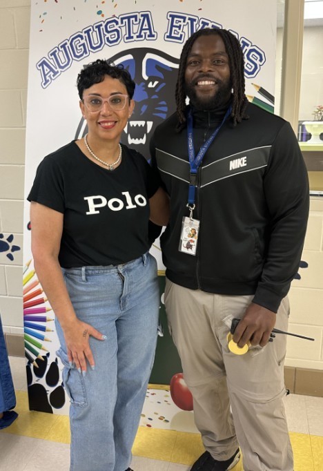 Mrs. Kidd with Mr. Binder in front of Teacher Appreciation sign 