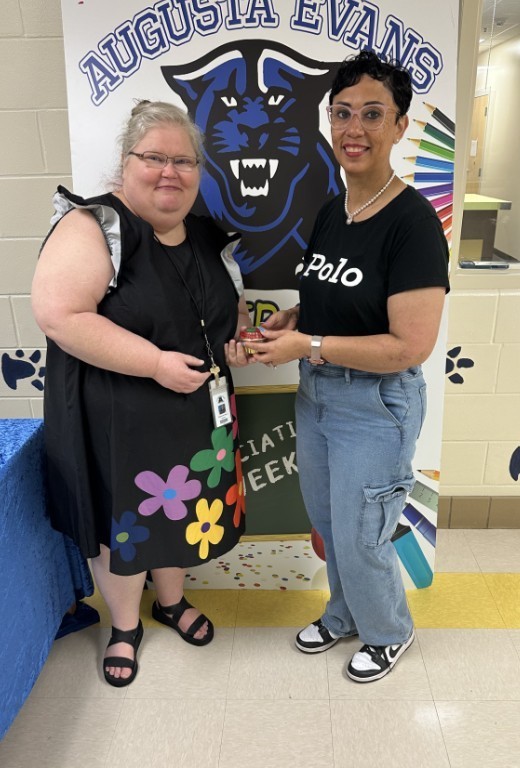 Mrs. Kidd and Cub level teacher holding a cupcake 