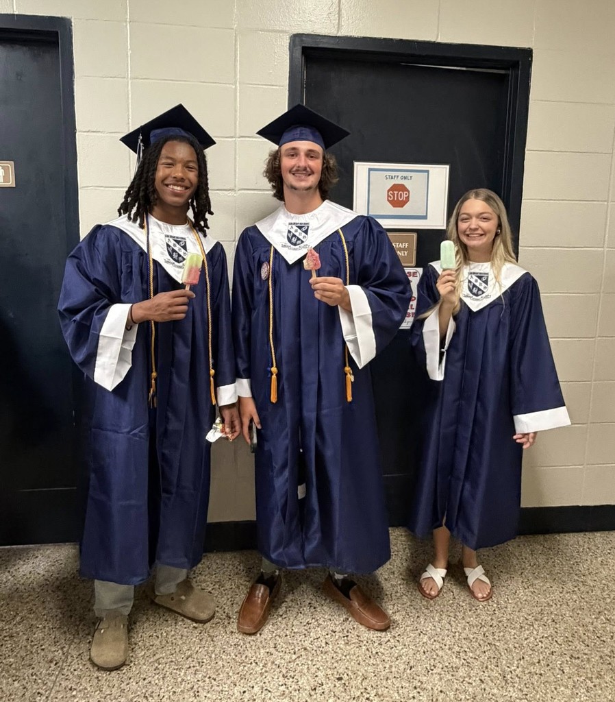Three seniors in blue caps and gowns holding ice cream