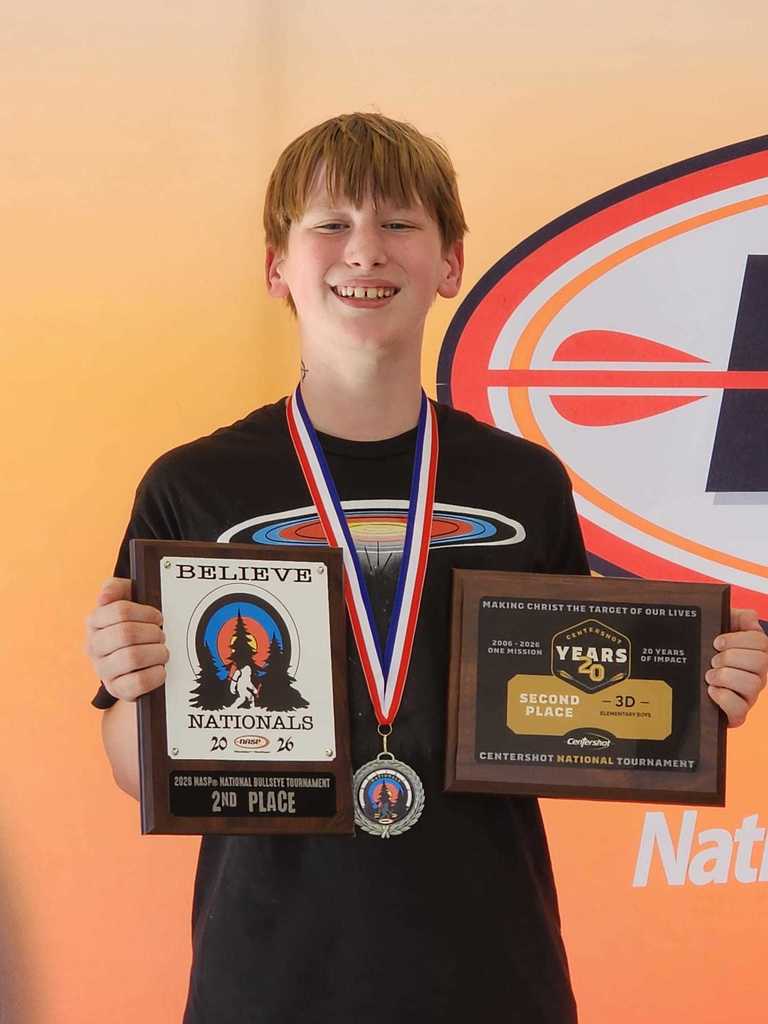 Student holding 3 archery awards