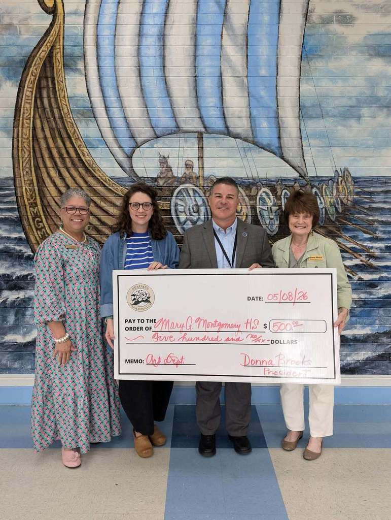 Mrs. McNellage and Mr. Diaz receiving a donation from the Semmes Woman's Club.