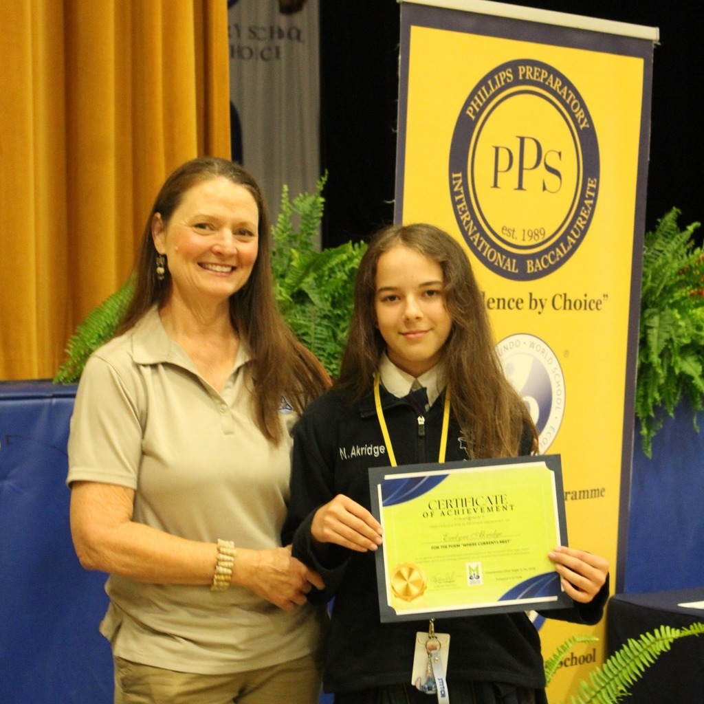 A Mobile Parks and Recreation employee stands with Eva Akridge, who holds a certificate