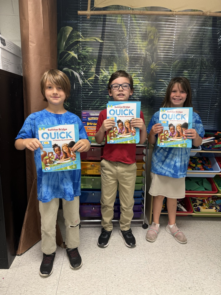 Second grade with their summer workbook