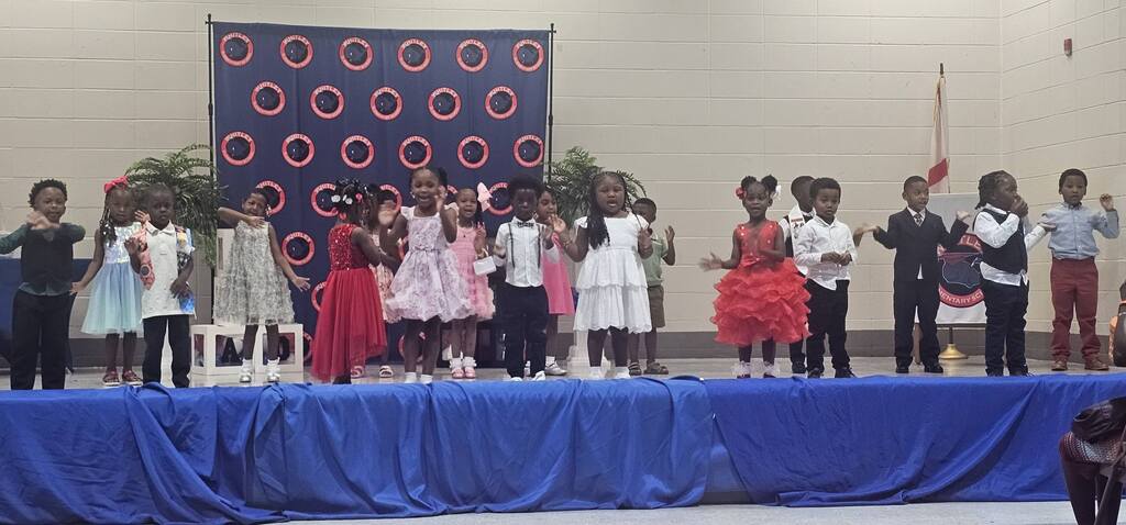Whitley Elementary kindergarten students on a stage