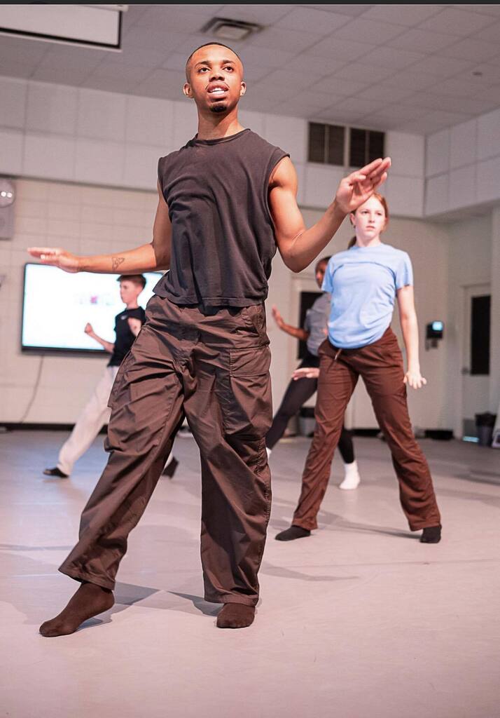 Tyrone Reese dancing, with Davidson High dancers behind him