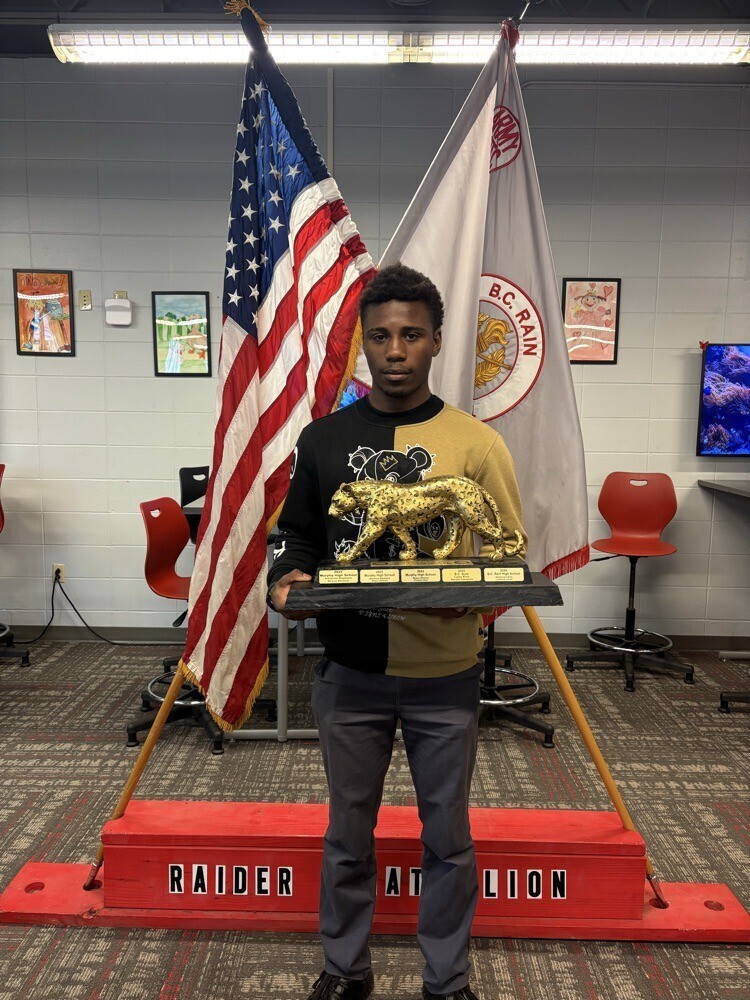 Laderick Jones holds the Jaguar Challenge trophy