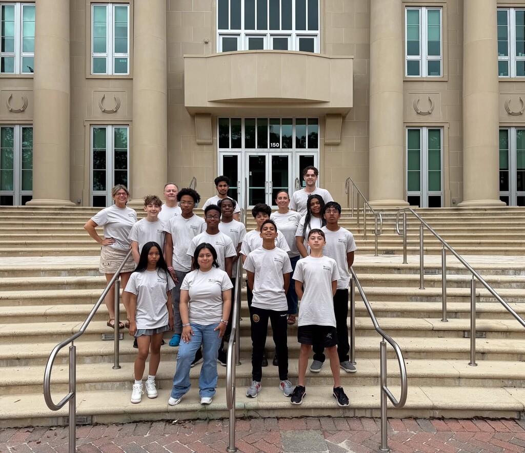 Davidson High students and teachers standing on the steps of a building at the University of South Alabama