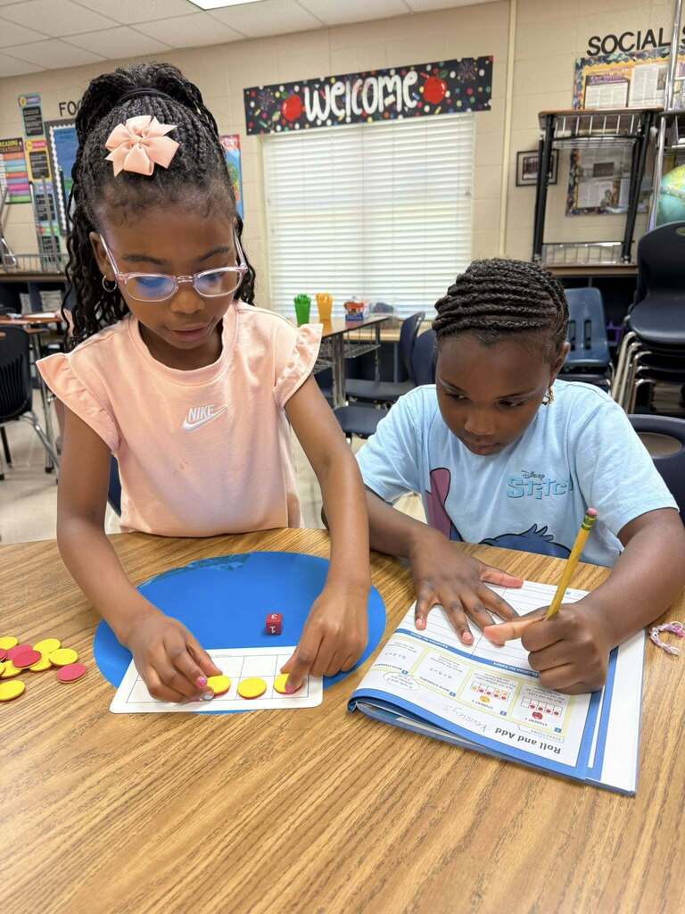 Two students work with math manipulatives