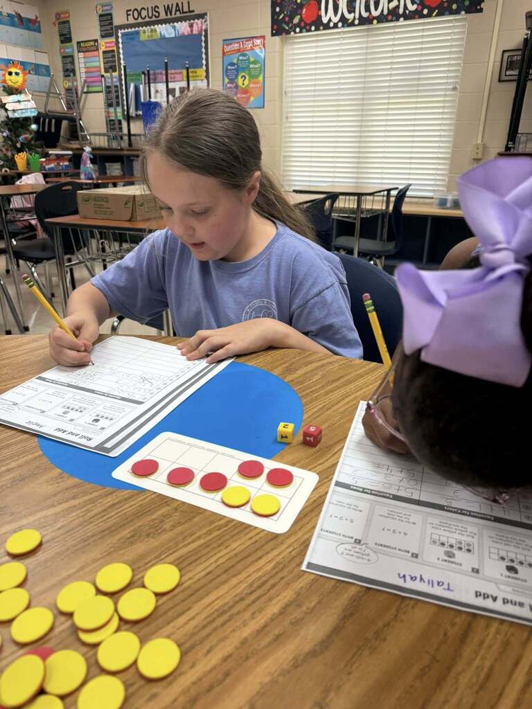 Two girls work with math manipulatives