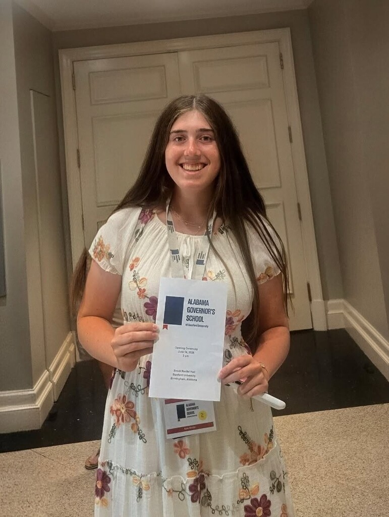 Kate Kertis, holding a certificate from the Alabama Governor's School