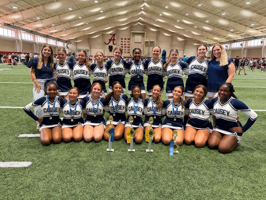 The Causey Middle cheerleaders, posing for a group photo at the University of Alabama indoor football facility