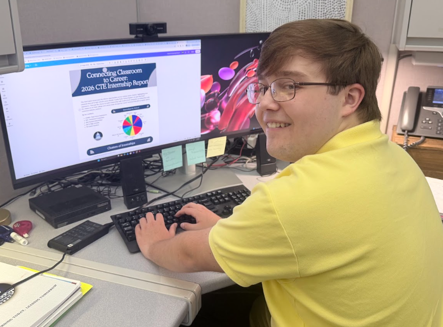 A high school student working at a computer