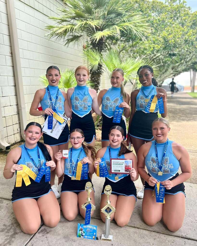 Mary G. Montgomery dance team members, with ribbons and trophies