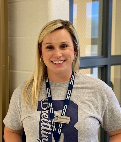 Chasity Barbour, wearing a lanyard and a Breitling T-shirt