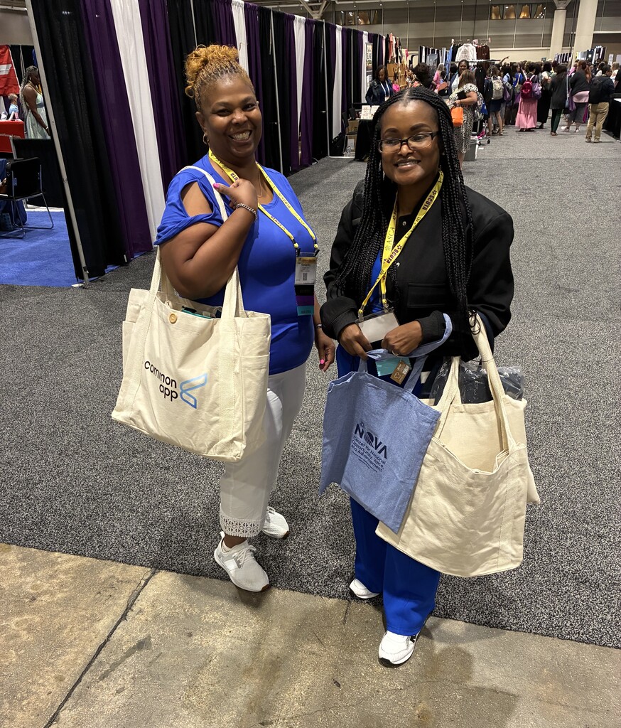 Two school counselors wearing lanyards and holding bookbags