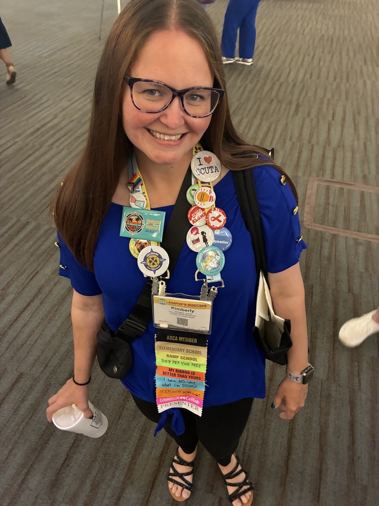 A school counselor wearing an array of buttons and ribbons on a lanyard
