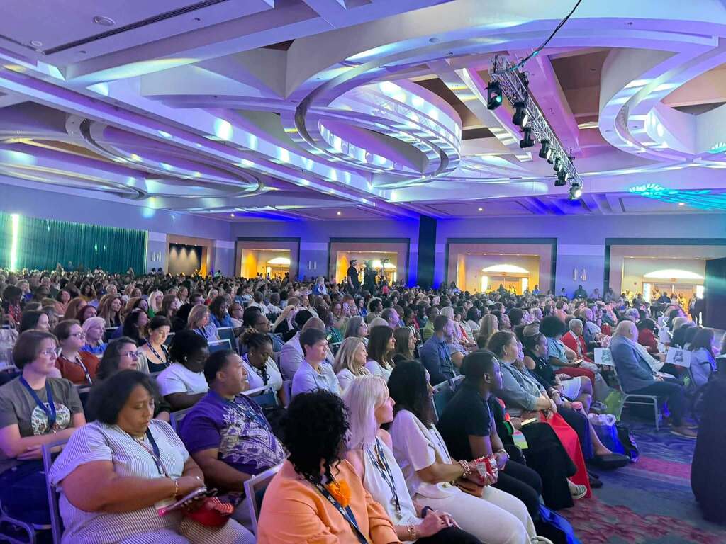 A conference room full of teachers seated in chairs
