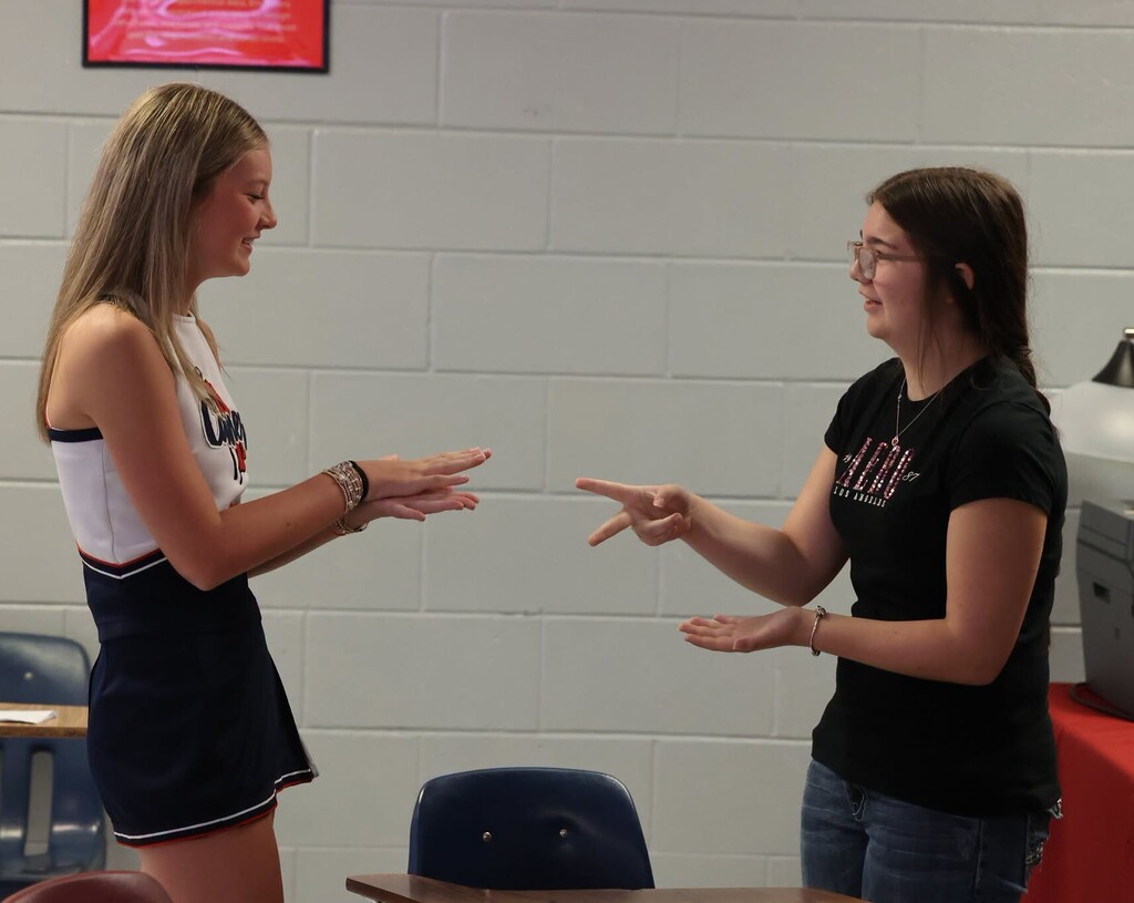 Two girls playing rock, paper, scissors