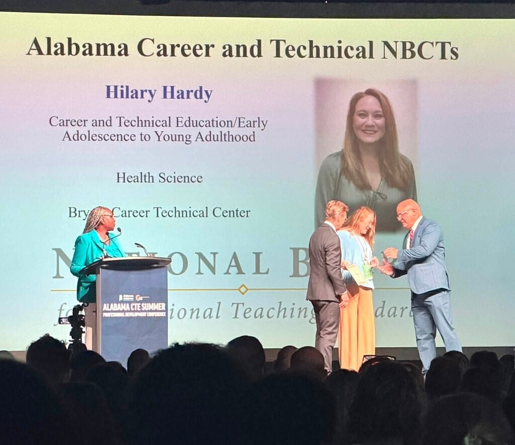 Hilary Hardy is honored on stage for her National Board Certification