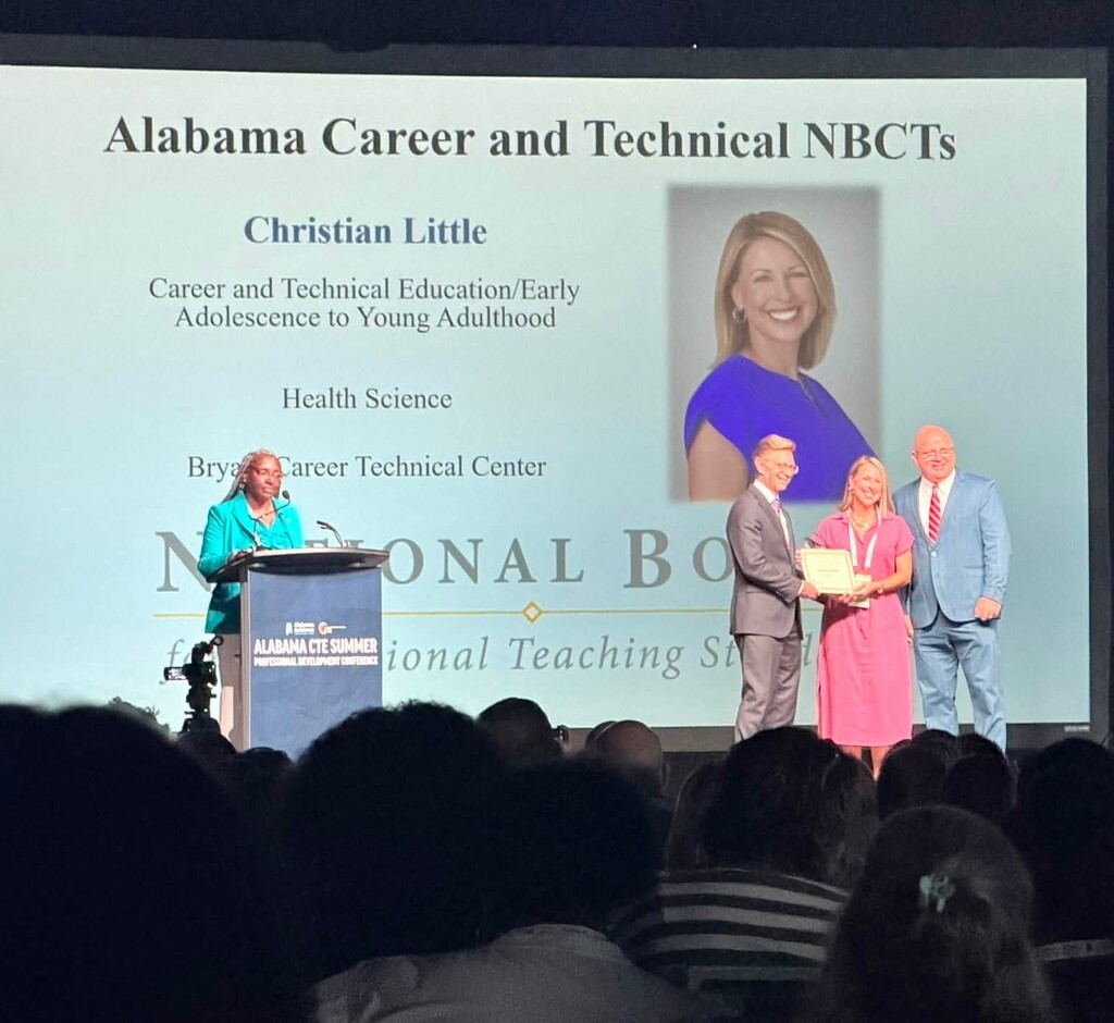 Christian Little is honored on stage for her National Board Certification