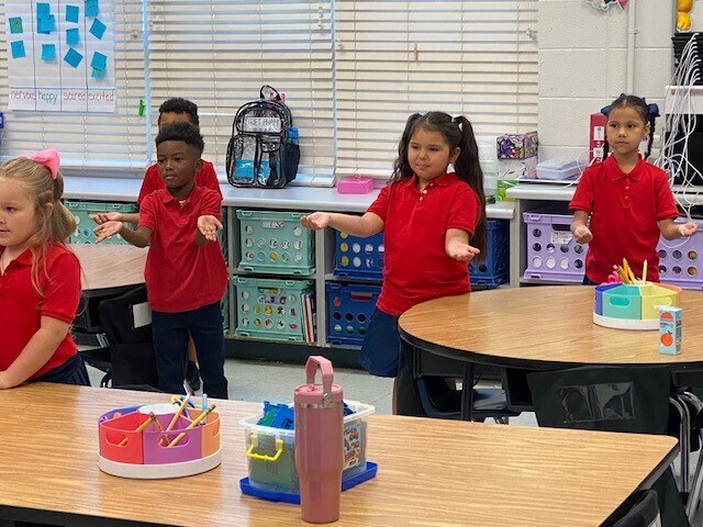 Students doing the macarena while learning about the seasons.