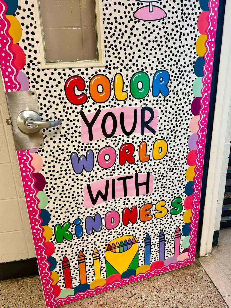 A door with the words "Color your World with Kindness"