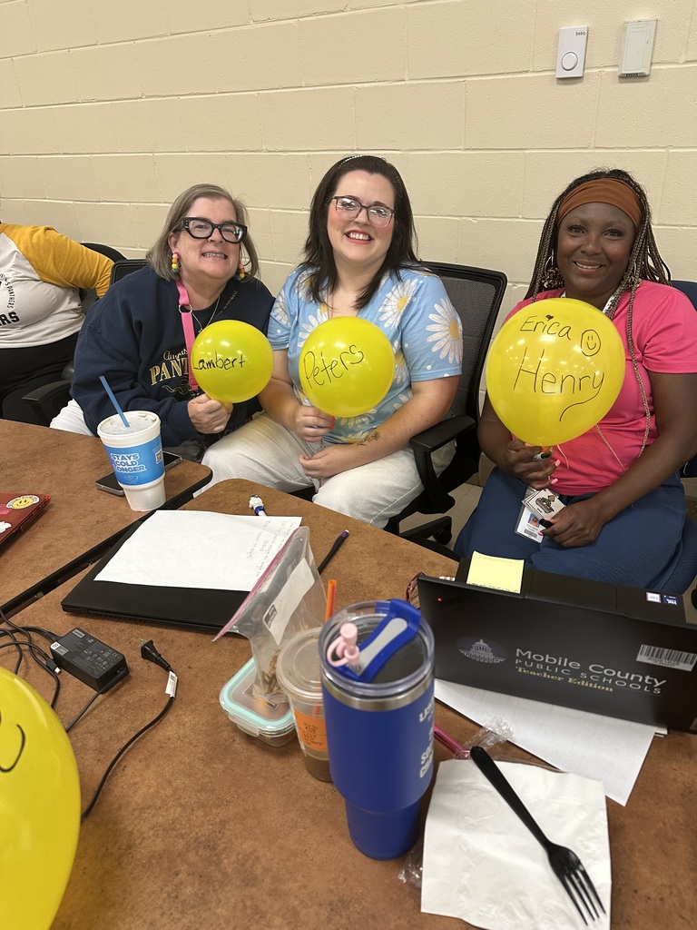 Leopard level teachers holding yellow balloons during a learning launch activity