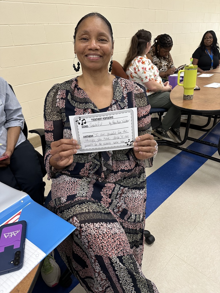 Mrs. Griggs holding her song inspiration card for the 2026-2027 school year