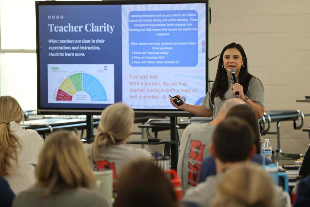 A woman speaking in a room full of teachers