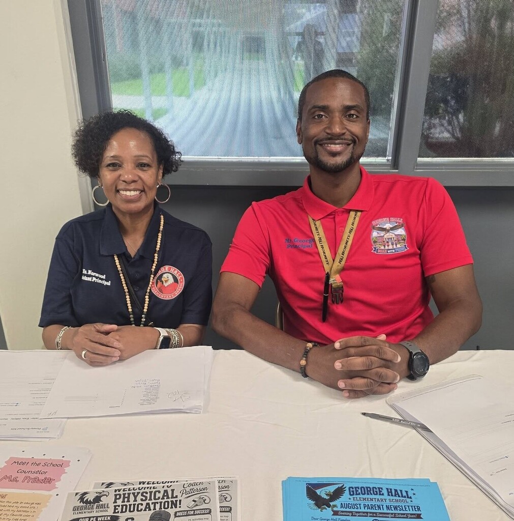 George Hall Elementary's principal and assistant principal sit at a table