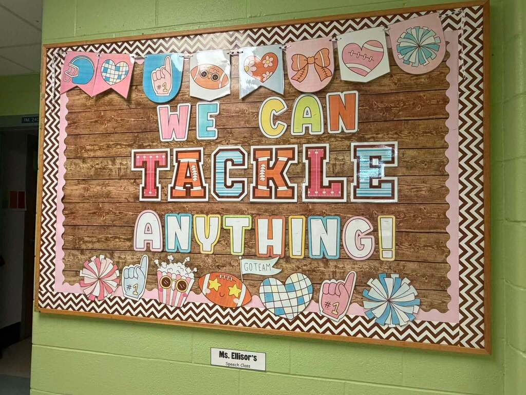 A bulletin board that reads "We can tackle anything!"
