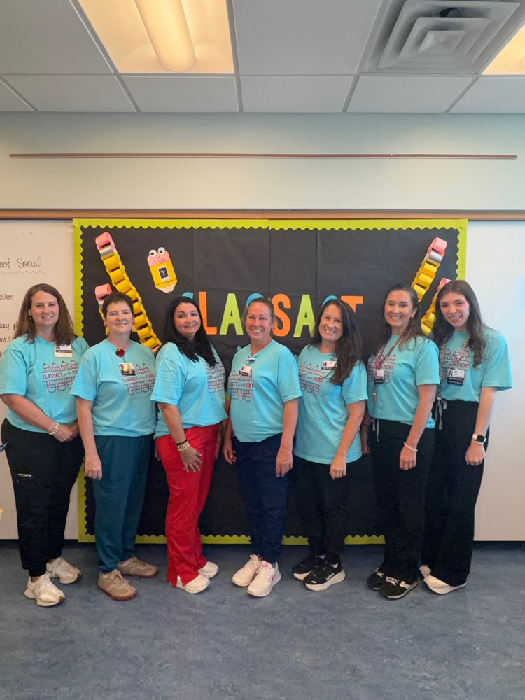 teachers lined up in front of board