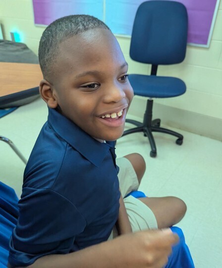 Cub level student smiling in the classroom