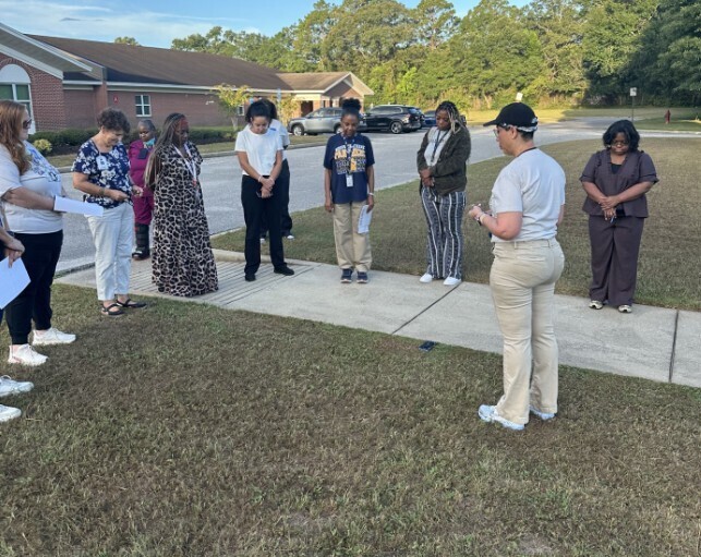 Mrs. Kidd giving a word of encouragement to her staff at 7am on the first day of school