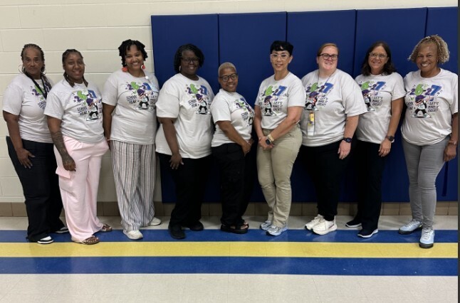 Group staff photo in matching new school year shirts