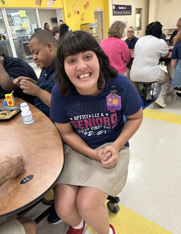 Cougar level student smiling on the first day of school in the lunch room