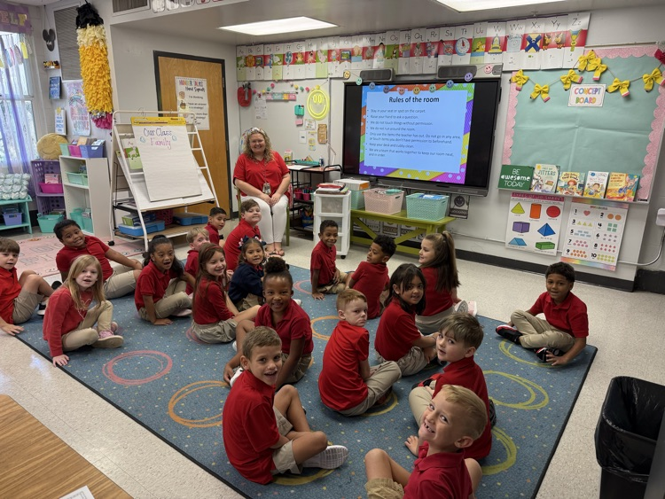 mrs. collier’s first grade class students sitting on a rug