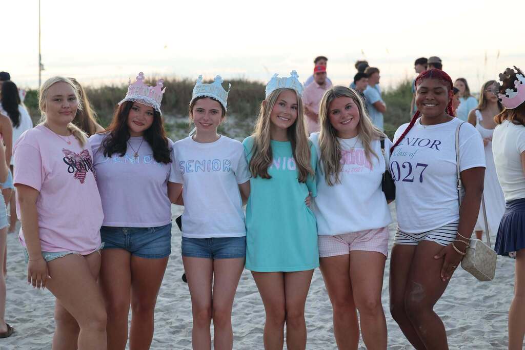 Six high school girls standing on a beach