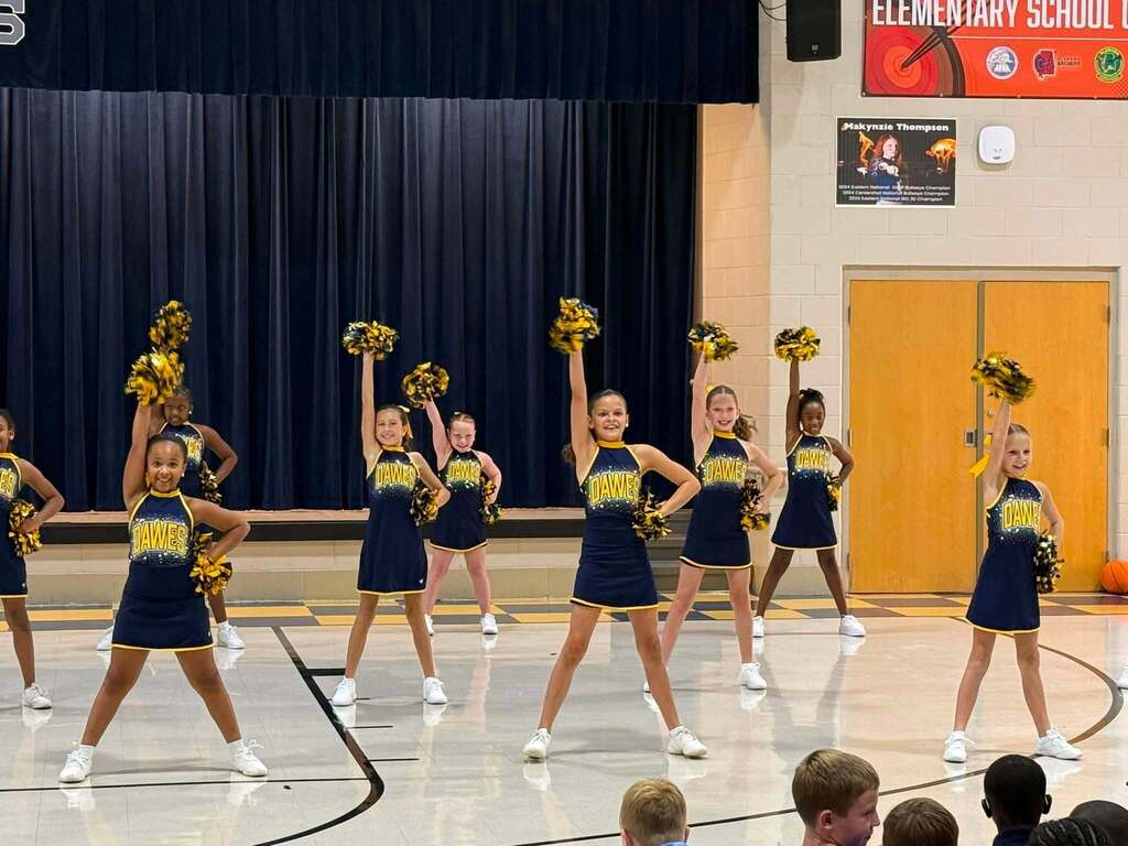 Cheerleaders performing in a gymnasium