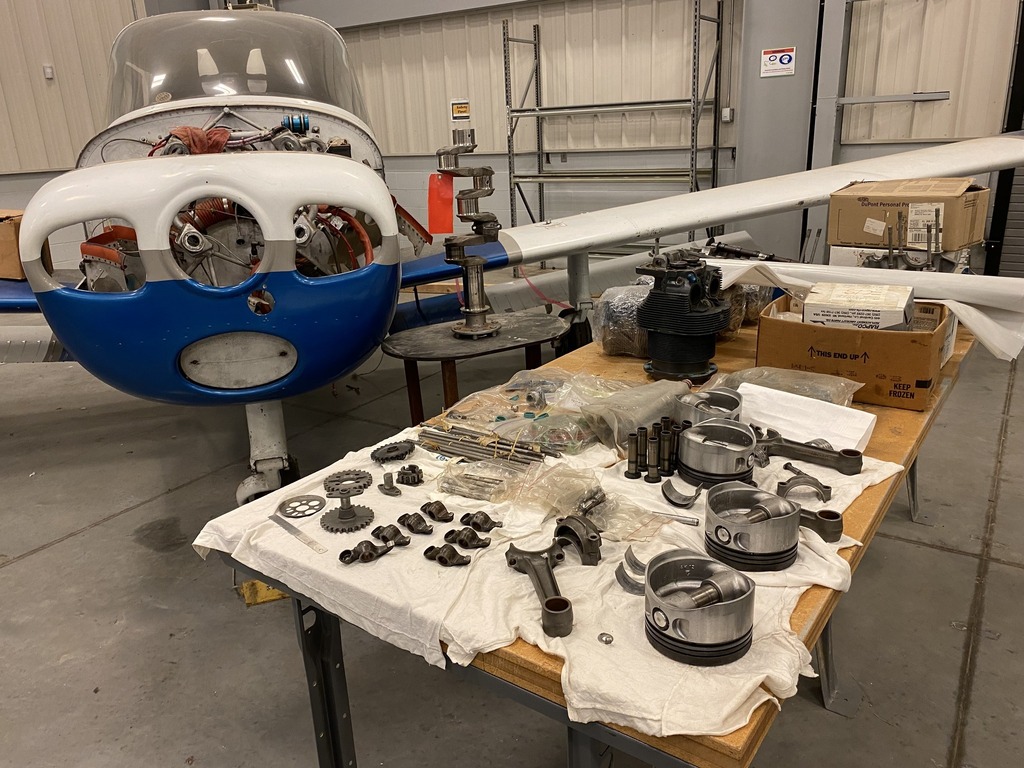 An airplane with disassembled parts on a table