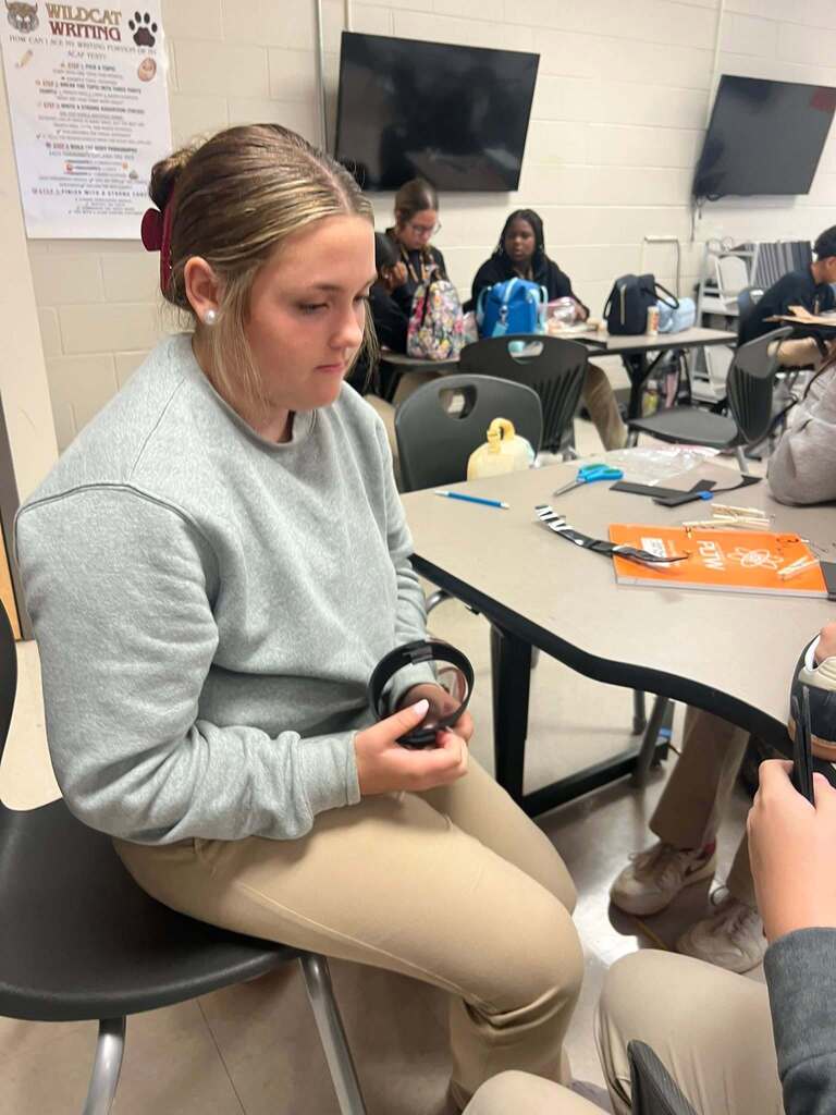 A girl holding a circular brace