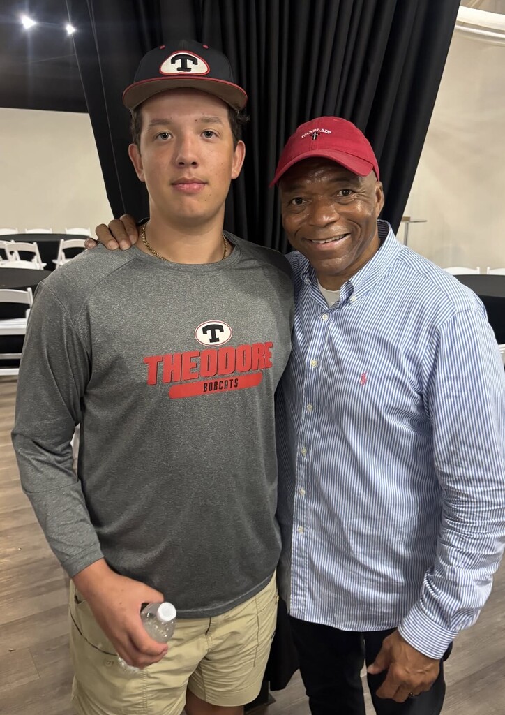 Jeremiah Castille stands with a Theodore football player