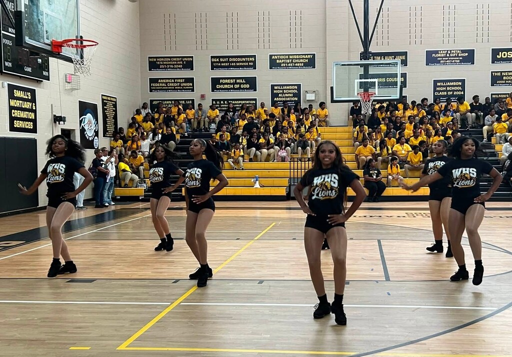 A dance team performing in a gymnasium