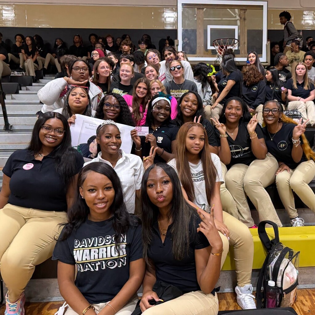 A group of students sitting in a gymnasium