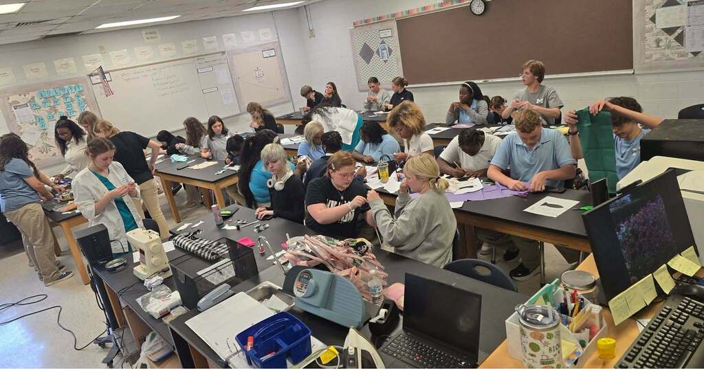Students working to complete their Lucky Fish in the Textile Club.