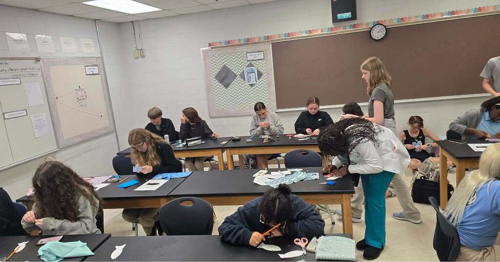 Students working to complete their Lucky Fish in the Textile Club.
