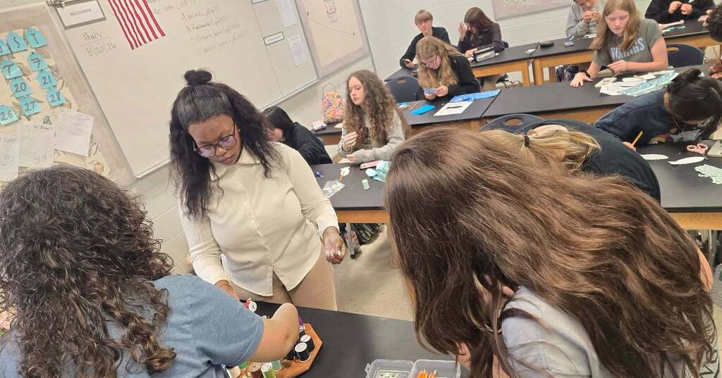 Students working to complete their Lucky Fish in the Textile Club.