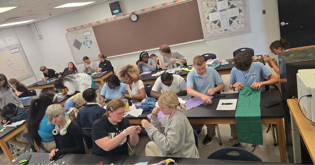 Students working to complete their Lucky Fish in the Textile Club.