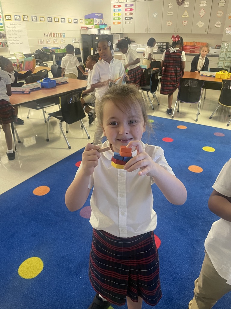 Students sorting shapes by their attributes while creating patterns.
