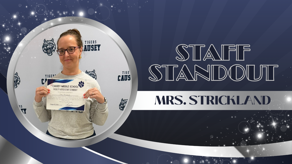A person stands in a spotlight, holding a certificate. Text reads "Staff Standout" and "Mrs. Strickland". Background has stars and a wolf logo.